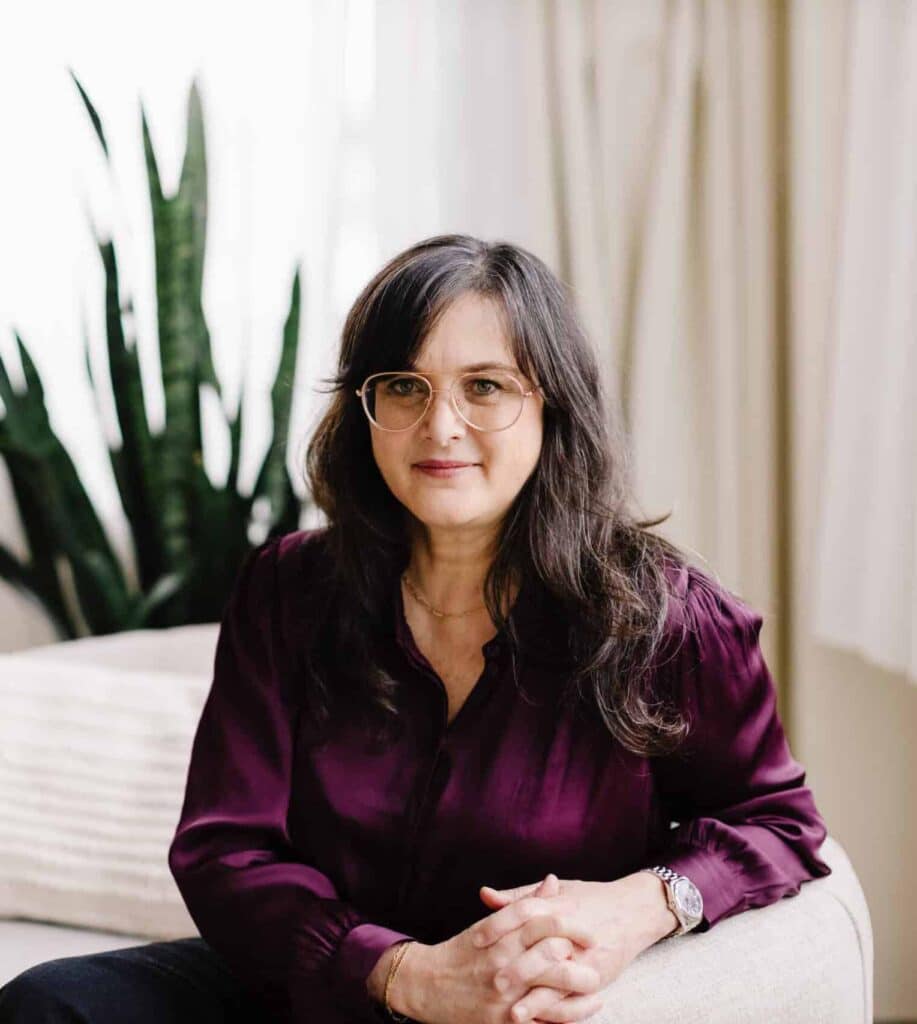 Dr Kine Fischler sitting in Willow Tree Acupuncture, a wellness center in Portland, Oregon.