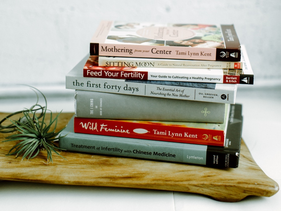 A stack of fertility and Chinese Medicine books including Treatment of Infertility with Chinese Medicine, reflecting the research-backed approach used at Willow Tree Clinic to enhance male and female fertility in Portland, OR.