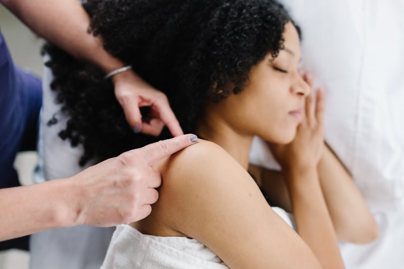 A person receiving an acupuncture treatment in their upper arm. reasons to add acupuncture to your spring wellness routine