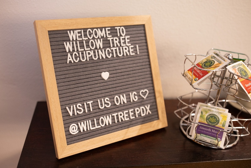 Welcome sign at Willow Tree Acupuncture with tea display, inviting visitors to connect on Instagram | acupuncture and cancer