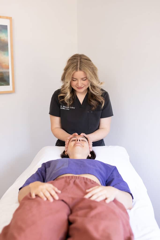 Doctor provides gentle facial acupuncture during a calming treatment session at Willow Tree Clinic. | acupuncture for pinched nerve pain
