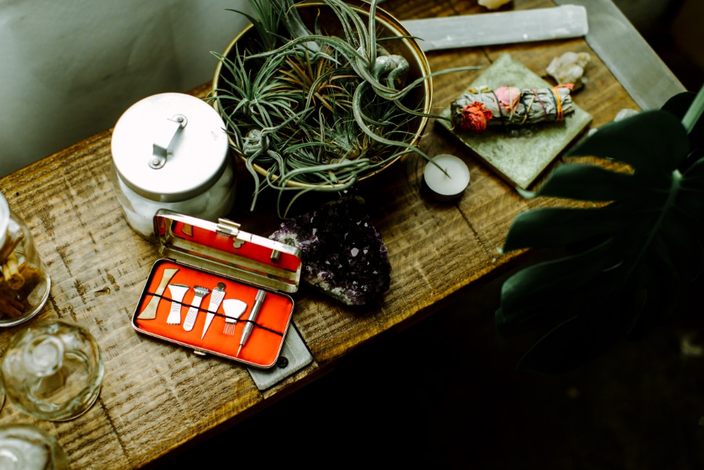 Acupuncture needles, herbal tools, and plants arranged on a wooden table inside an acupuncture clinic in Portland OR. | acupuncture for hashimoto's