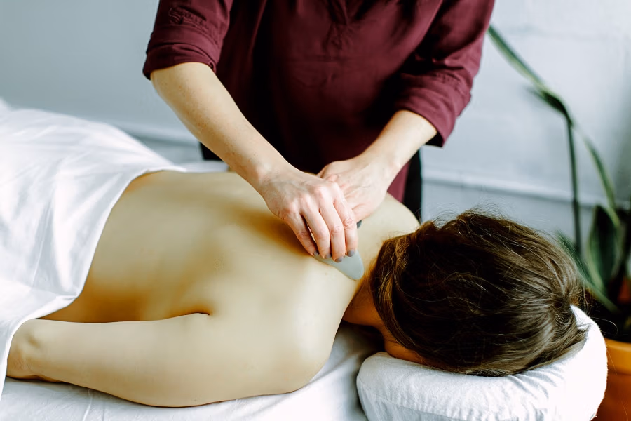 Acupuncture treatment on the upper back using gentle tools to release tension and improve circulation. These sessions help regulate the nervous system and are often included in IVF support in Portland OR to reduce stress during treatment.
