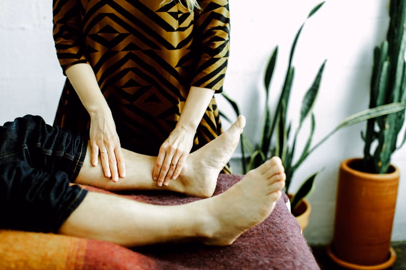 Acupuncture for hot flashes in Portland, OR often includes points on the lower legs, shown here as Dr. Fischler works on a patient's calf and ankle at Willow Tree. Leg points help calm the nervous system and ease the body's heat response.