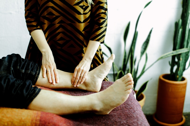 Acupuncture for hot flashes in Portland, OR often includes points on the lower legs, shown here as Dr. Fischler works on a patient's calf and ankle at Willow Tree. Leg points help calm the nervous system and ease the body's heat response.